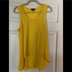 Yellow sleeveless high low top.